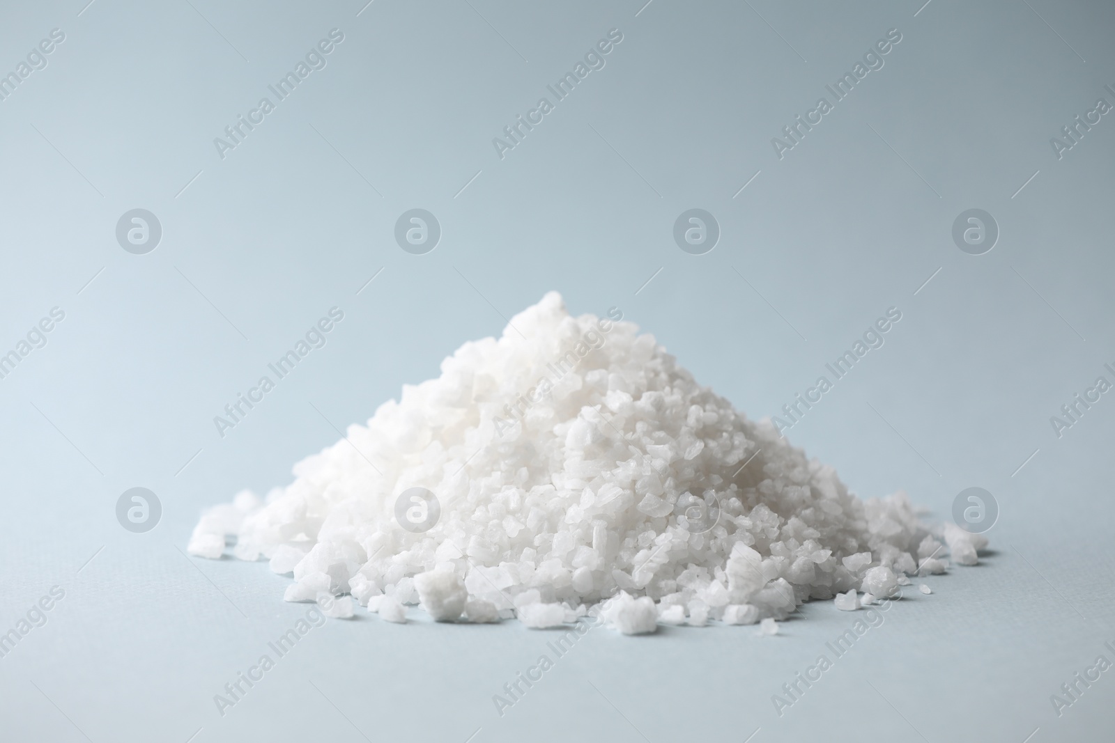 Photo of Heap of natural salt on color background