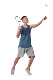 Young man playing badminton with racket and shuttlecock on white background