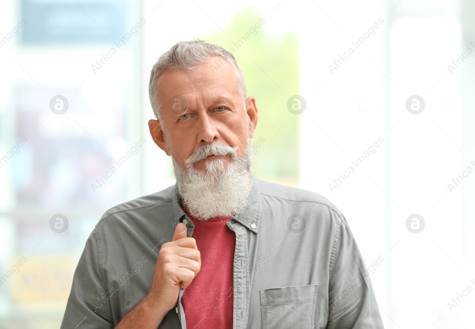 Photo of Portrait of handsome mature man against blurred background