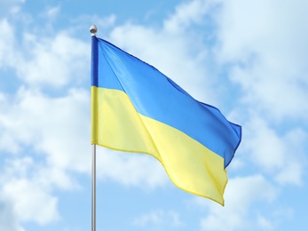 National flag of Ukraine fluttering on sunny day outdoors