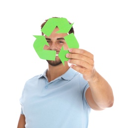 Young man with recycling symbol on white background