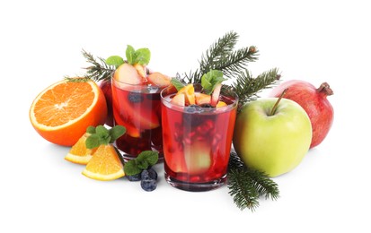 Aromatic Sangria drink in glasses, ingredients and Christmas decor on white background