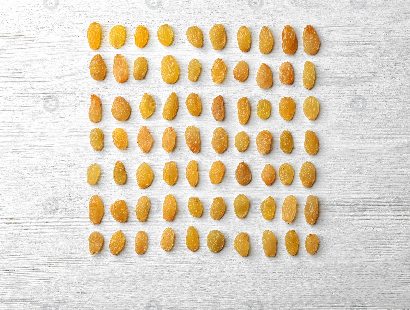 Photo of Flat lay composition with raisins on white wooden background. Dried fruit as healthy snack