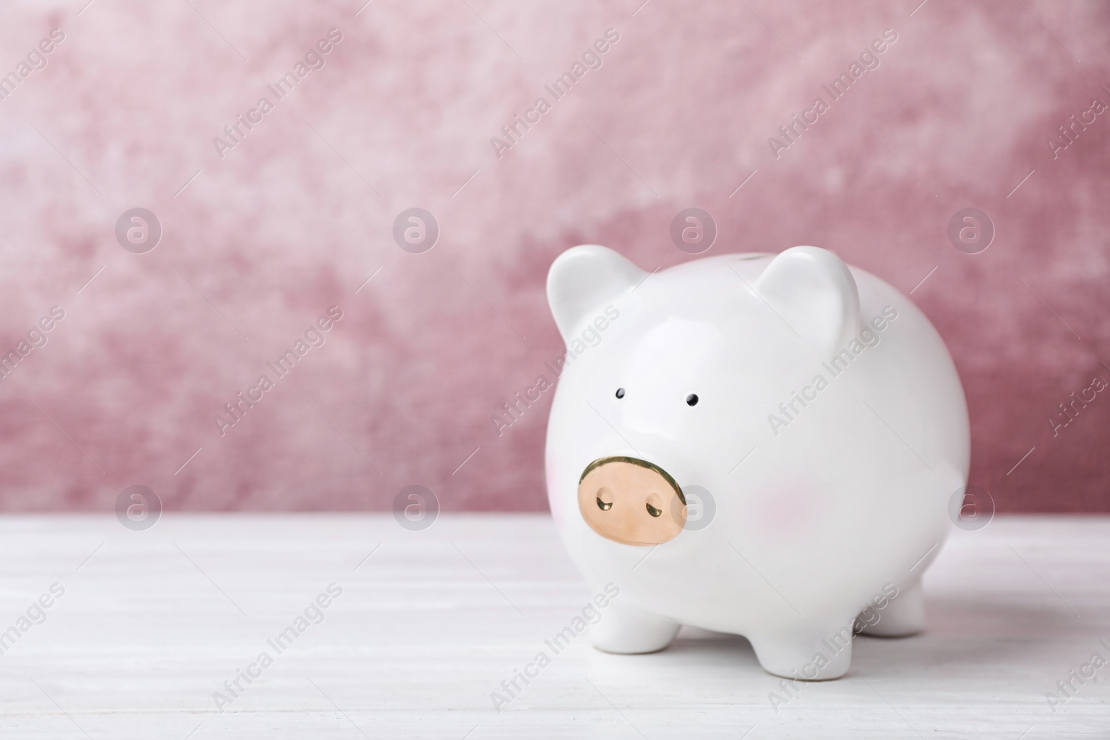 Photo of White piggy bank on table. Money saving