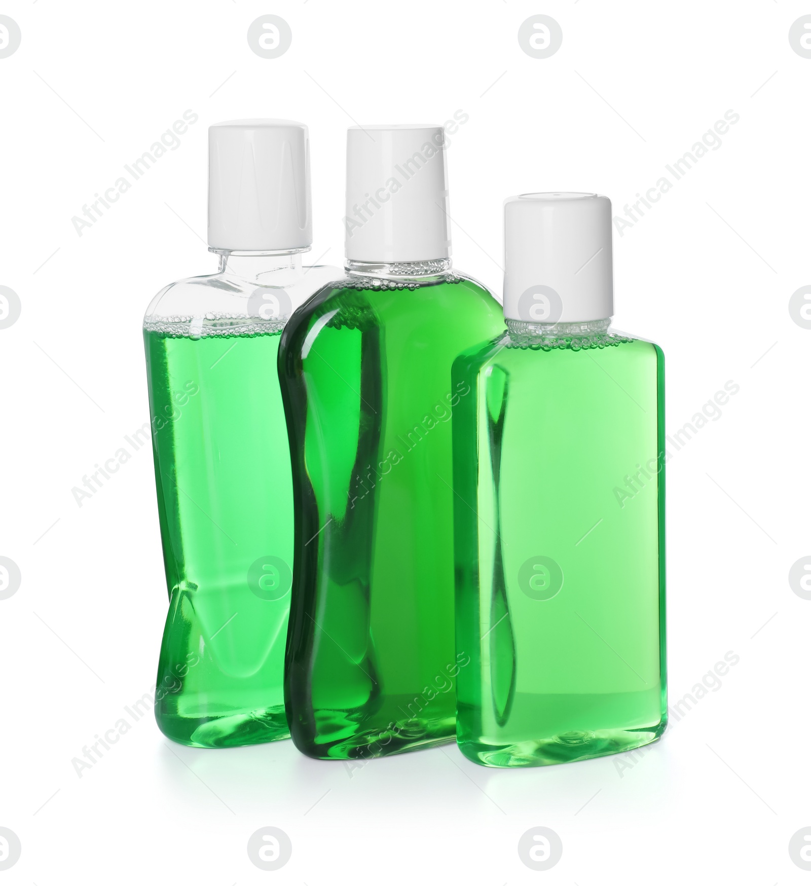 Photo of Three bottles of mouthwash isolated on white