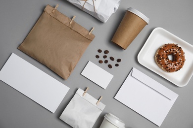 Photo of Flat lay composition with items for mock up design on gray background. Food delivery service