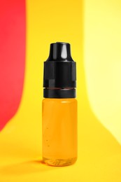 Photo of Bottle with orange food coloring on bright background