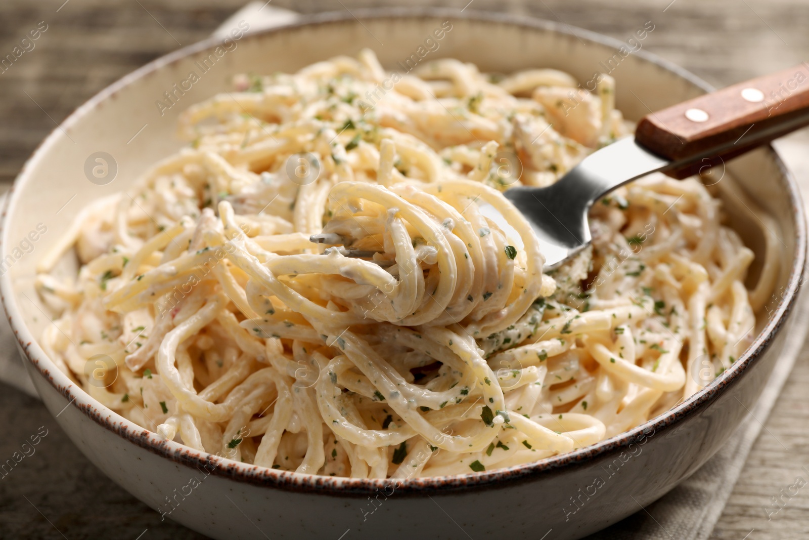 Photo of Delicious pasta with mushroom sauce on wooden table, closeup