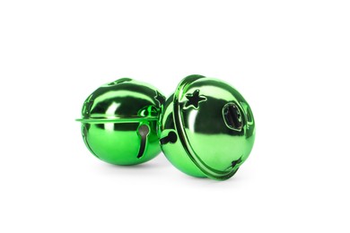 Photo of Shiny green sleigh bells on white background
