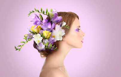 Image of Pretty woman wearing beautiful wreath made of flowers on lilac background