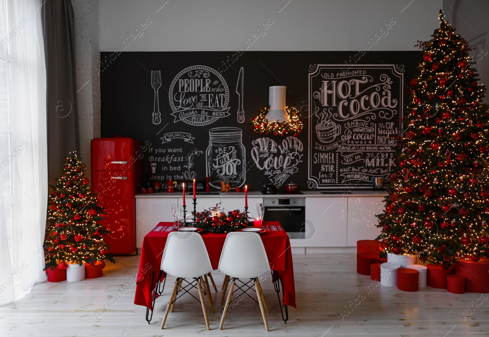 Photo of Stylish kitchen interior with festive table and decorated Christmas tree