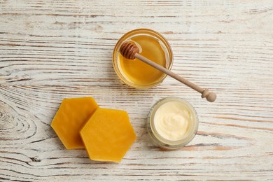 Photo of Natural beeswax, cream and honey on white wooden table, flat lay