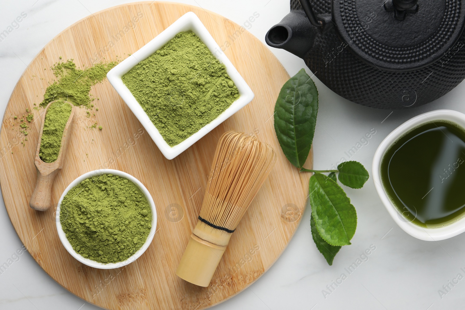 Photo of Flat lay composition with green matcha powder on white marble table