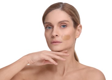 Photo of Woman with swatch of foundation on face against white background