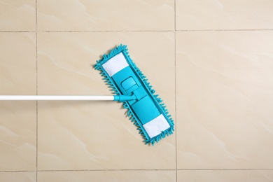 Photo of Cleaning of floor with mop, top view. Space for text