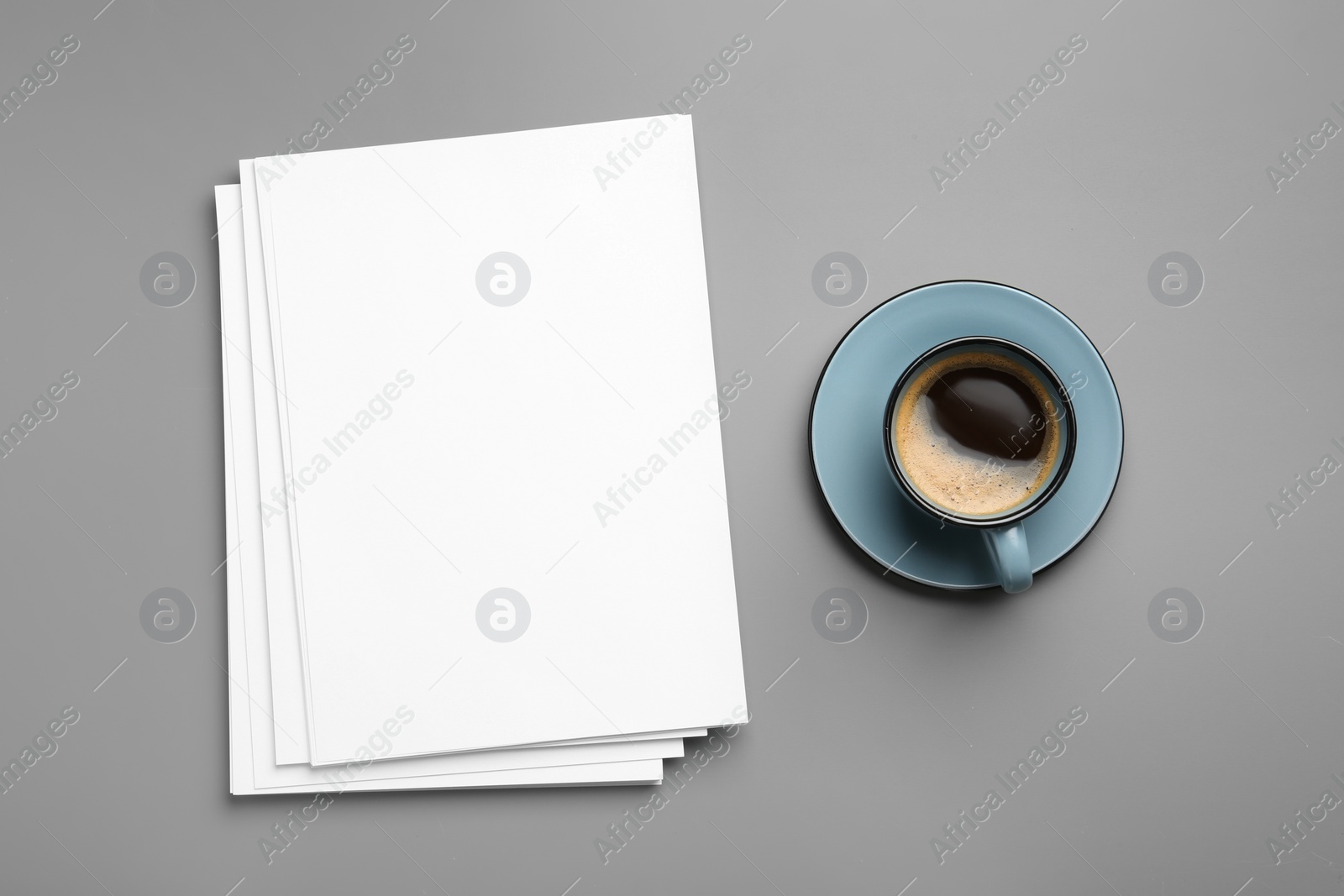 Photo of Blank paper sheets for brochure and cup of coffee on grey background, flat lay. Mock up