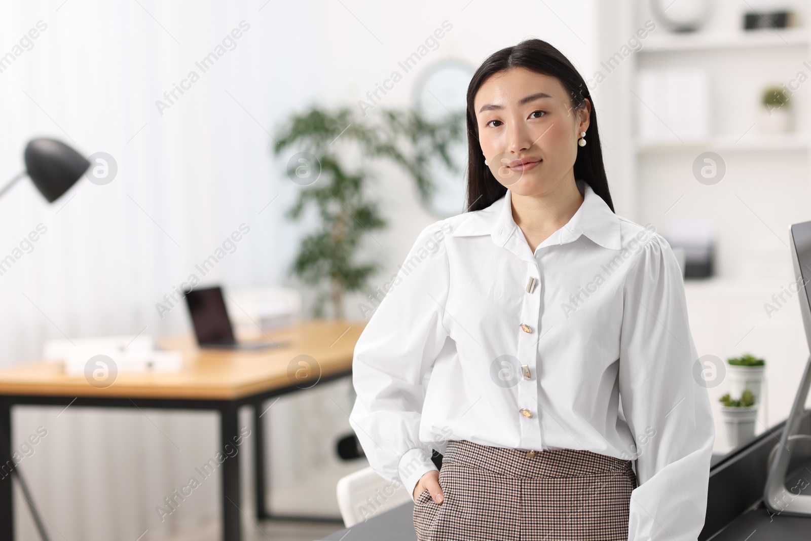 Photo of Portrait of beautiful businesswoman in office. Space for text