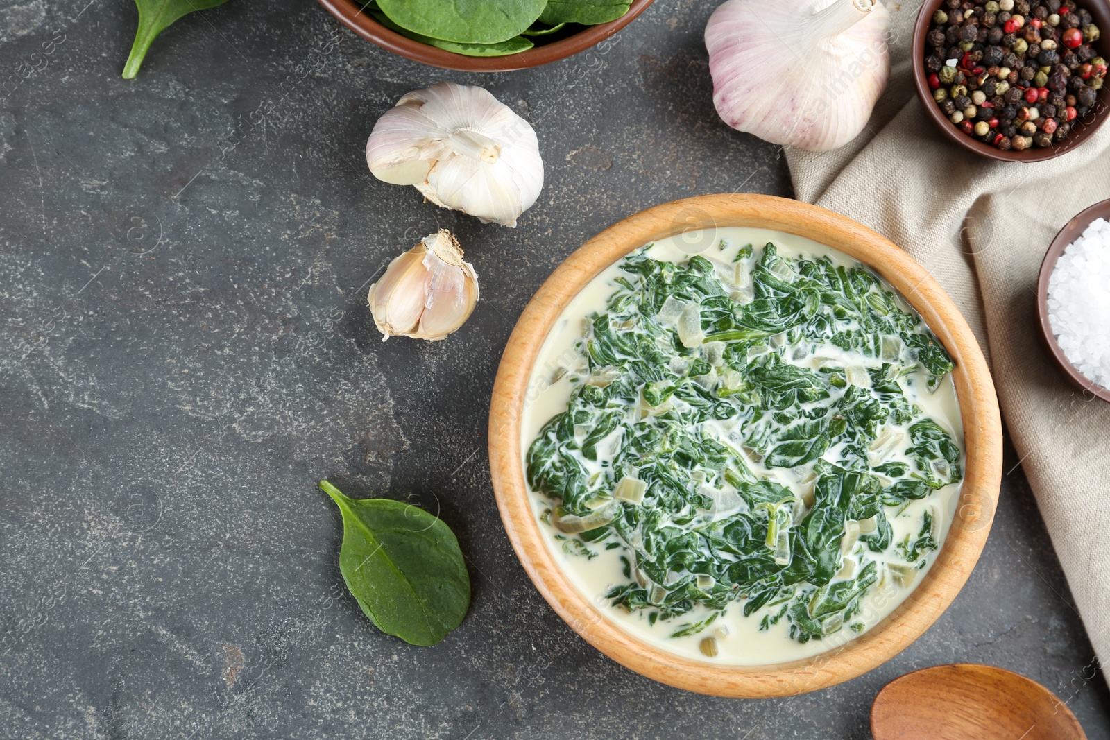 Photo of Tasty spinach dip on grey table, flat lay