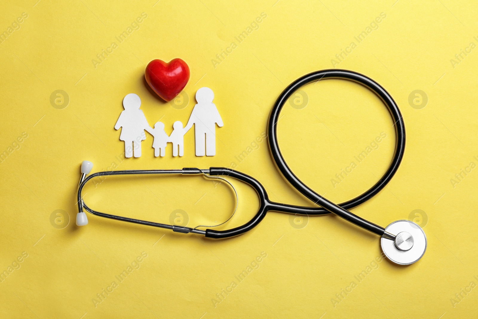 Photo of Flat lay composition with heart, stethoscope and paper silhouette of family on color background. Life insurance concept