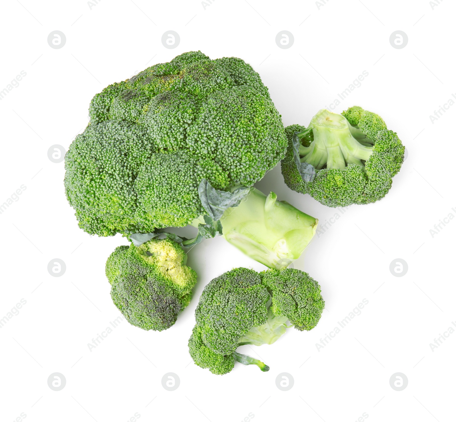 Photo of Pile of fresh raw green broccoli isolated on white, top view