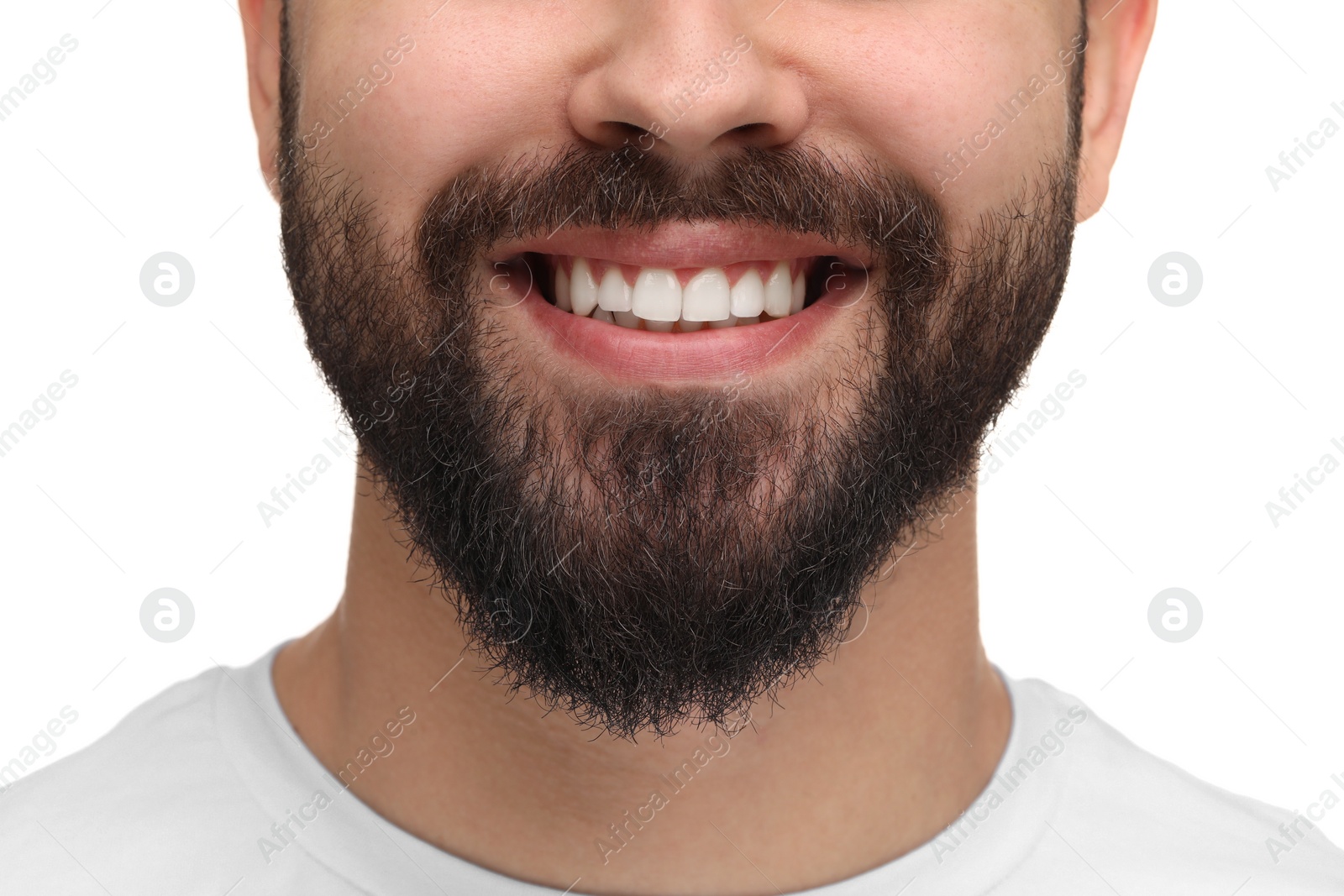 Photo of Man with clean teeth smiling on white background, closeup