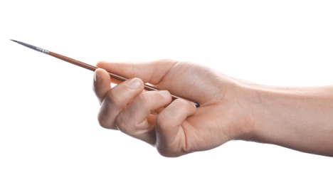 Photo of Man holding paint brush on white background, closeup