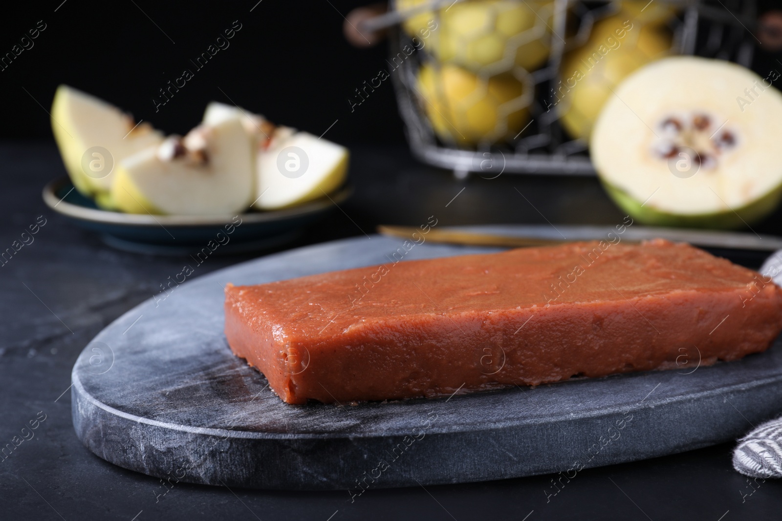 Photo of Delicious quince paste served on black table