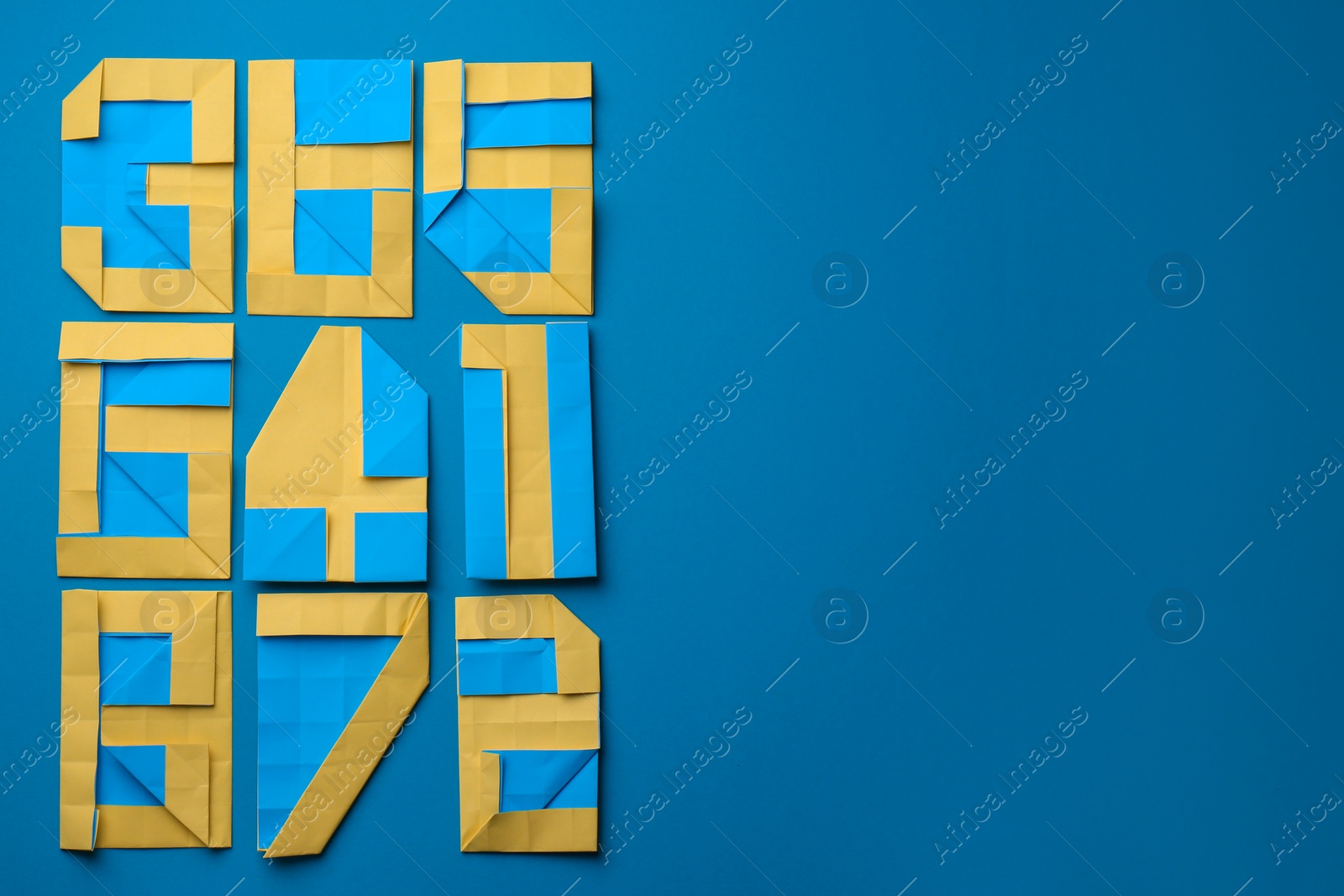 Photo of Different numbers made of paper on light blue background, flat lay. Space for text