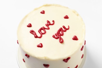 Photo of Bento cake with text Love You on white table, closeup. St. Valentine's day surprise