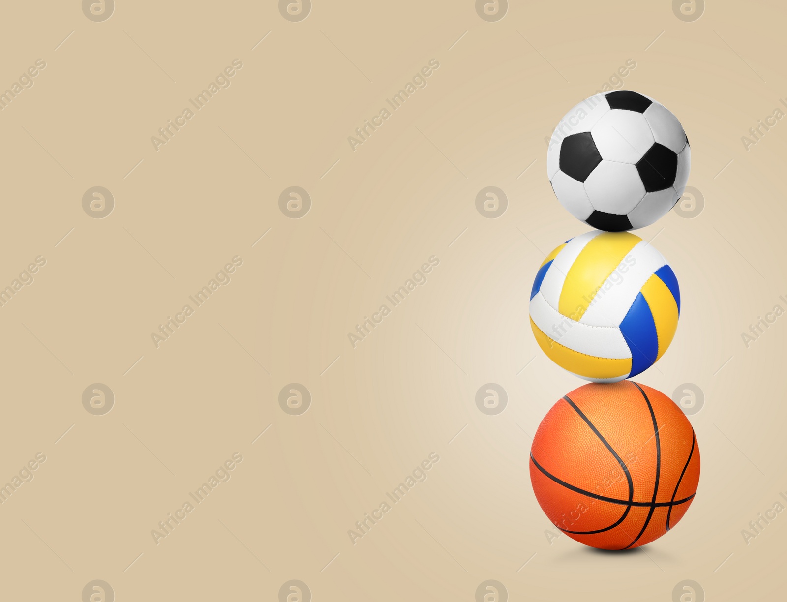 Image of Stack of different sport balls on beige background, space for text