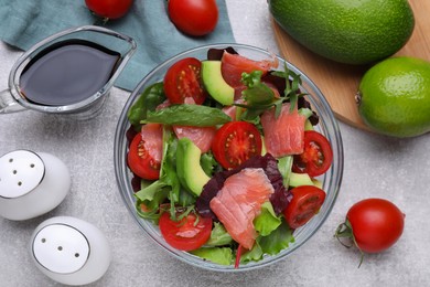 Photo of Soy sauce, salad and ingredients on grey table, flat lay