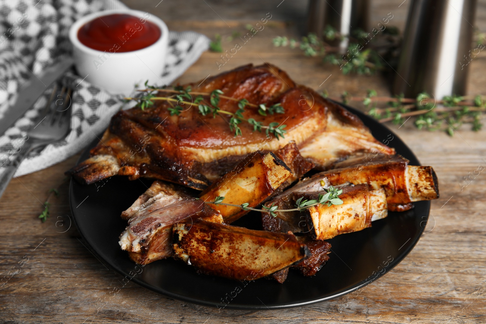 Photo of Delicious roasted ribs served on wooden table