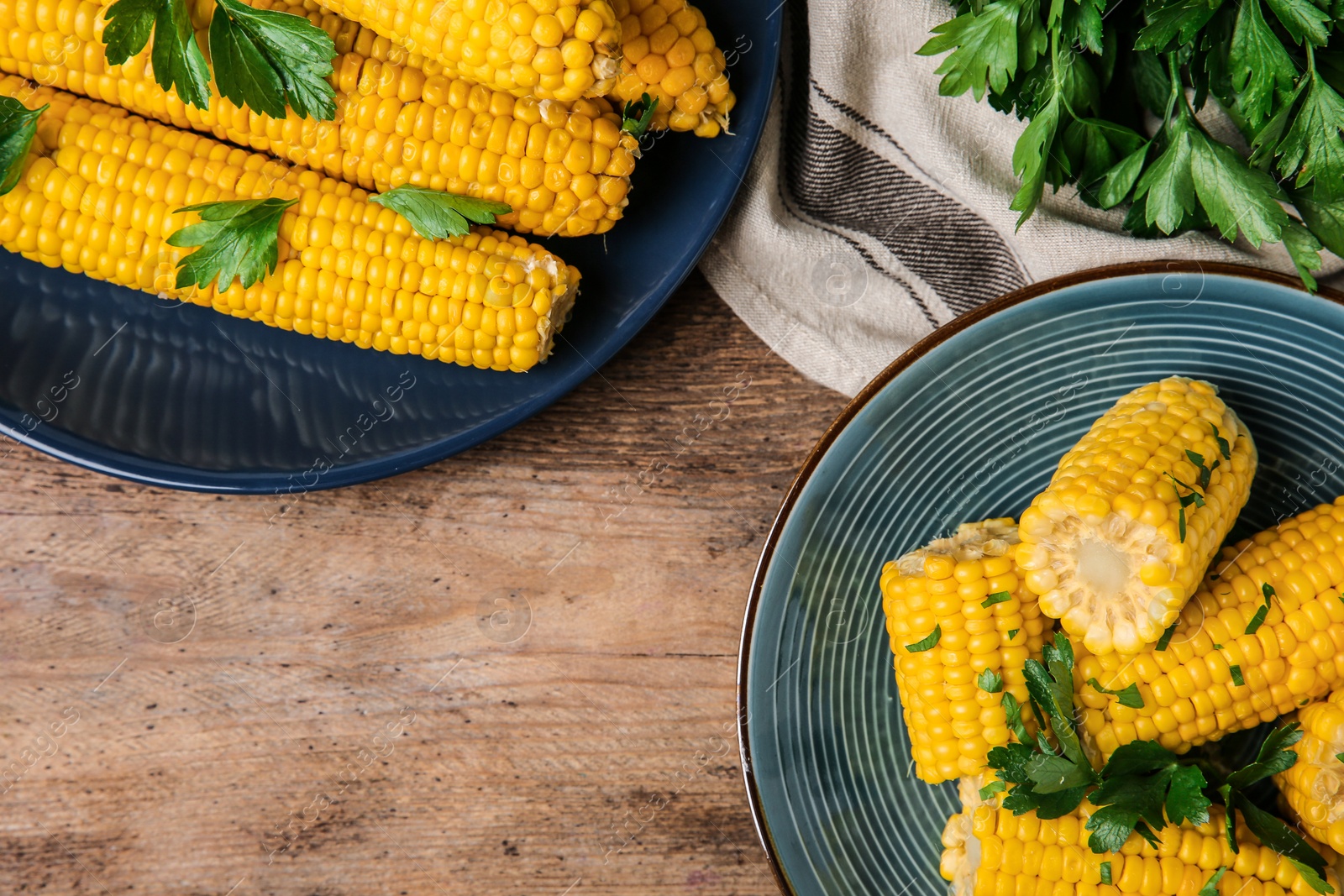 Photo of Flat lay composition of boiled corn cobs on wooden table