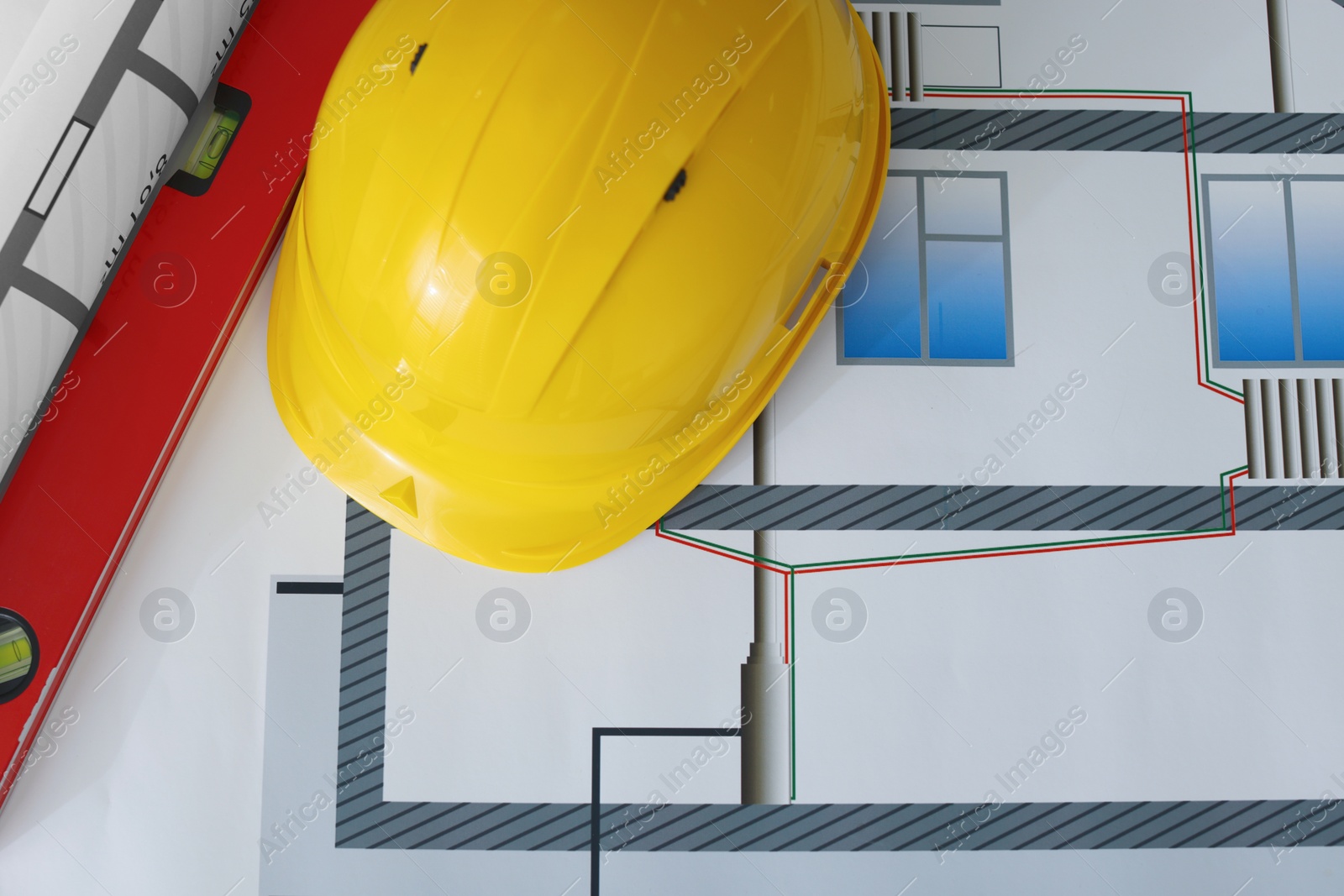 Photo of Construction drawings, safety hat and ruler, flat lay