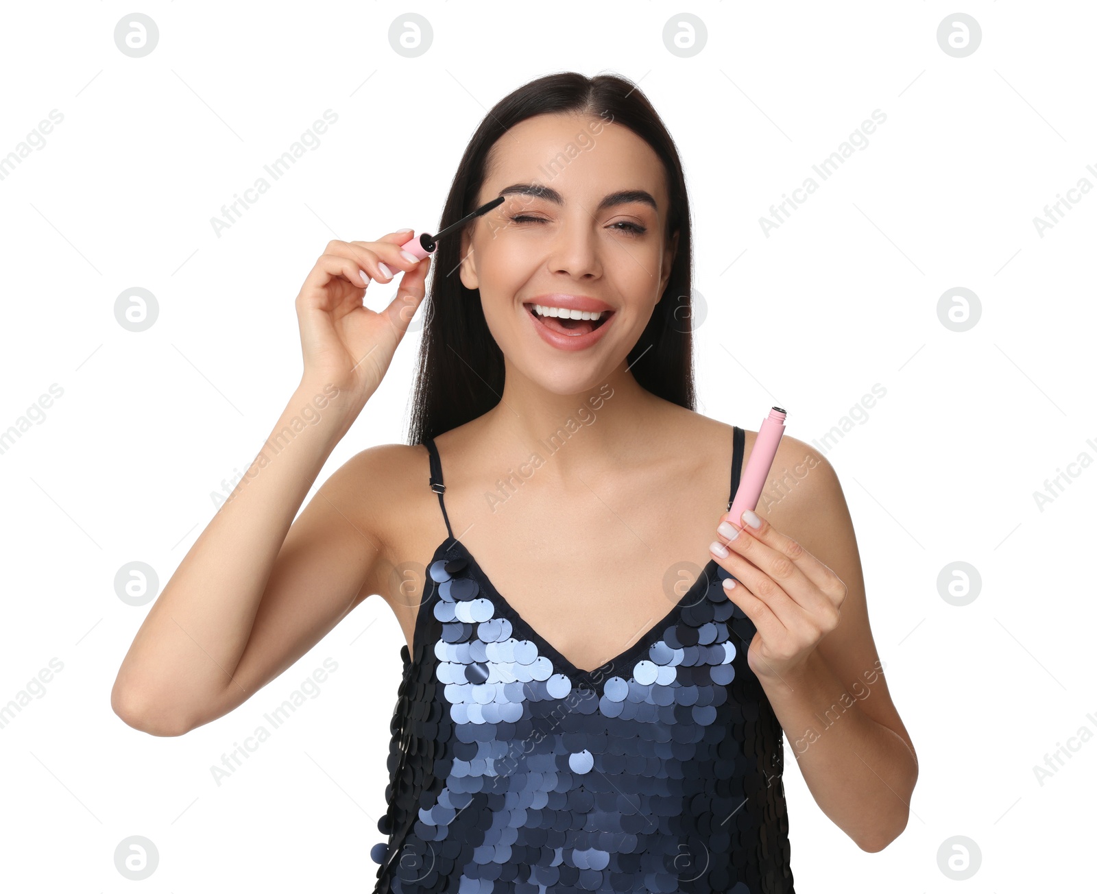 Photo of Beautiful young woman applying mascara on white background