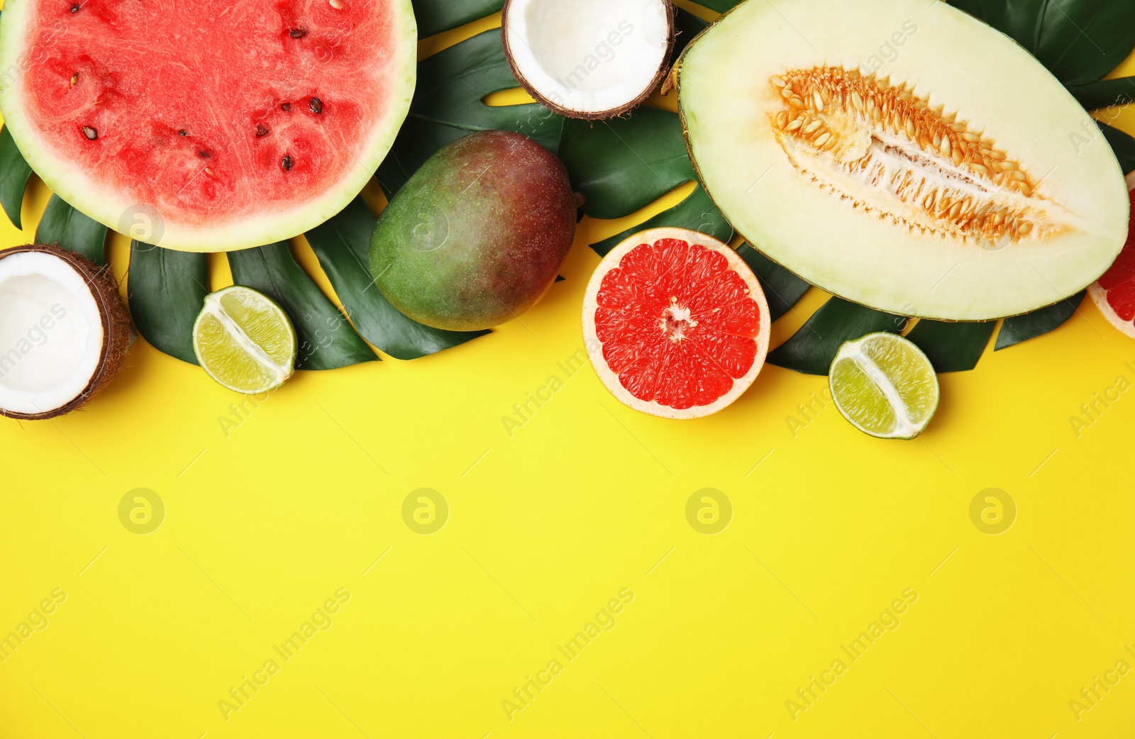 Photo of Flat lay composition with melon, other fruits and space for text on color background