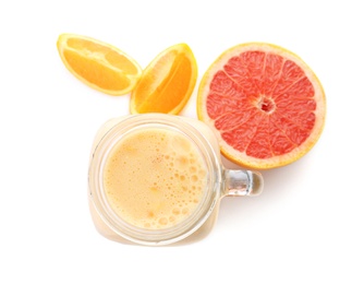 Mason jar with healthy detox smoothie and grapefruit on white background, top view