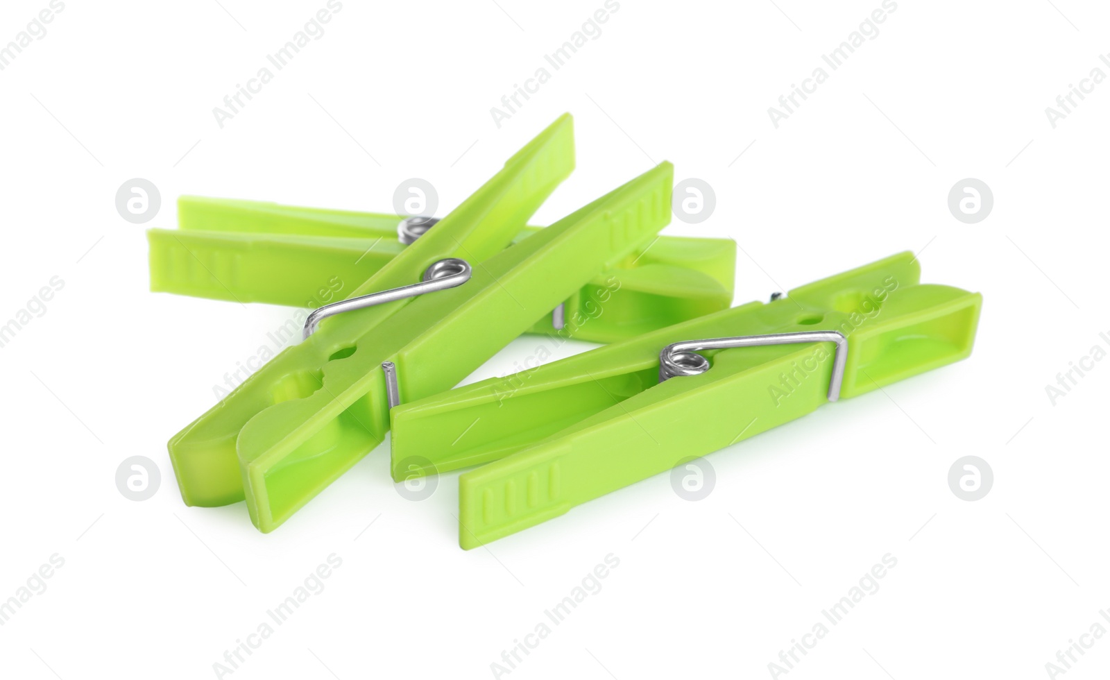 Photo of Bright green plastic clothespins on white background