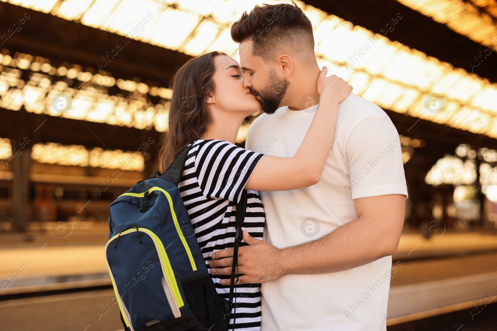 Photo of Long-distance relationship. Beautiful couple kissing on platform of railway station