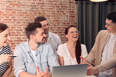 Team of employees working together in office