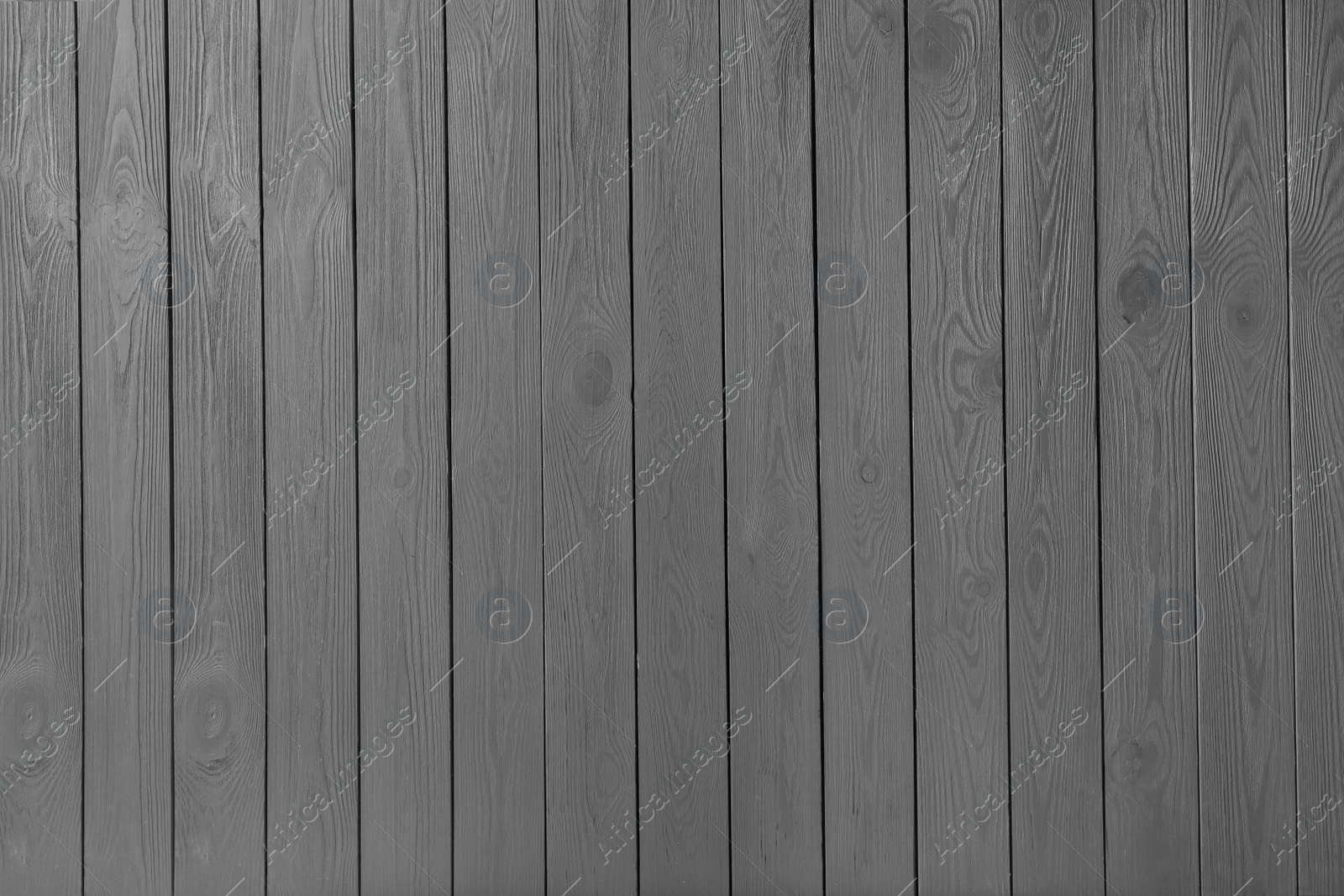 Photo of Texture of grey wooden board on black background, top view