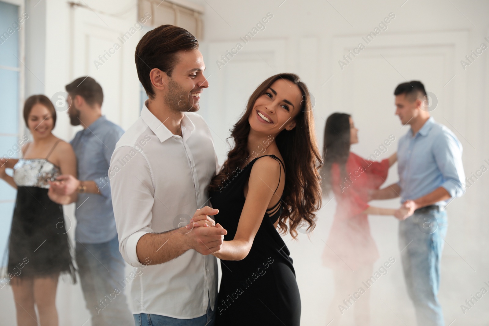 Photo of Lovely young couple dancing together at party