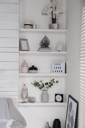 Photo of Wall shelves with beautiful decor elements indoors. Interior design