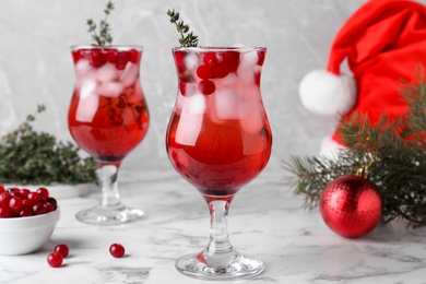 Delicious Christmas liqueur on white marble table, closeup