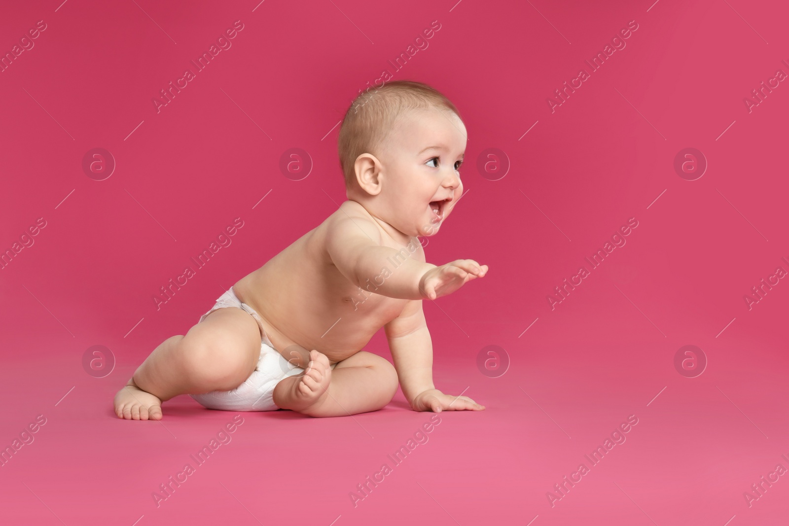 Photo of Cute little baby in diaper on pink background