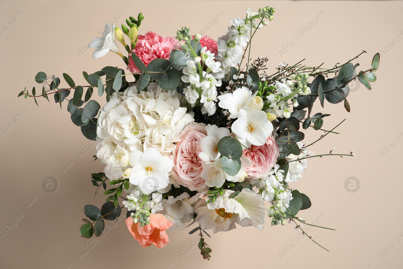 Photo of Bouquet of beautiful flowers on beige background, top view