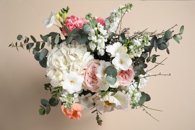 Photo of Bouquet of beautiful flowers on beige background, top view