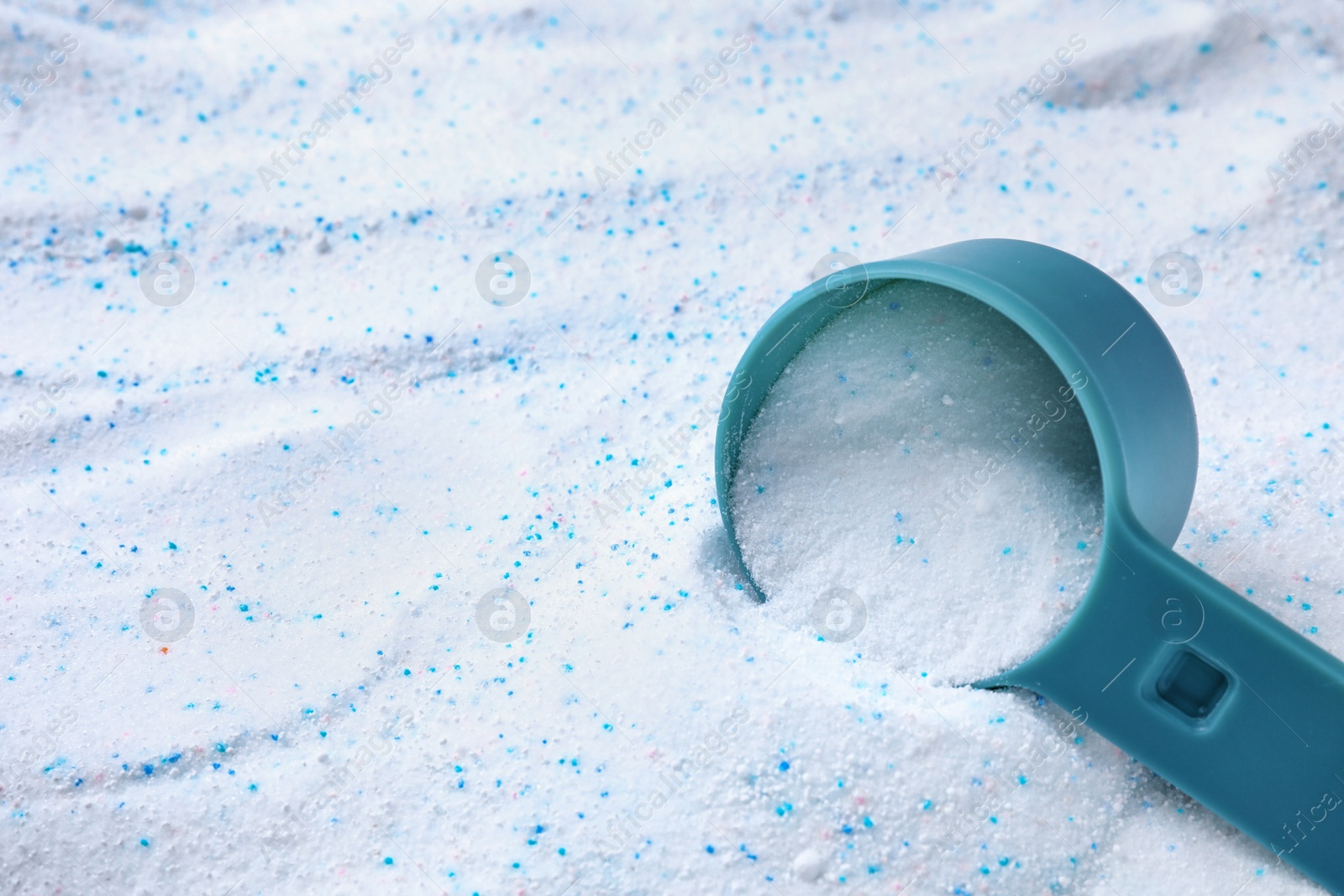 Photo of Measuring spoon with laundry powder, above view with space for text