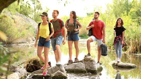 Photo of Group of friends hiking outdoors. Camping vacation