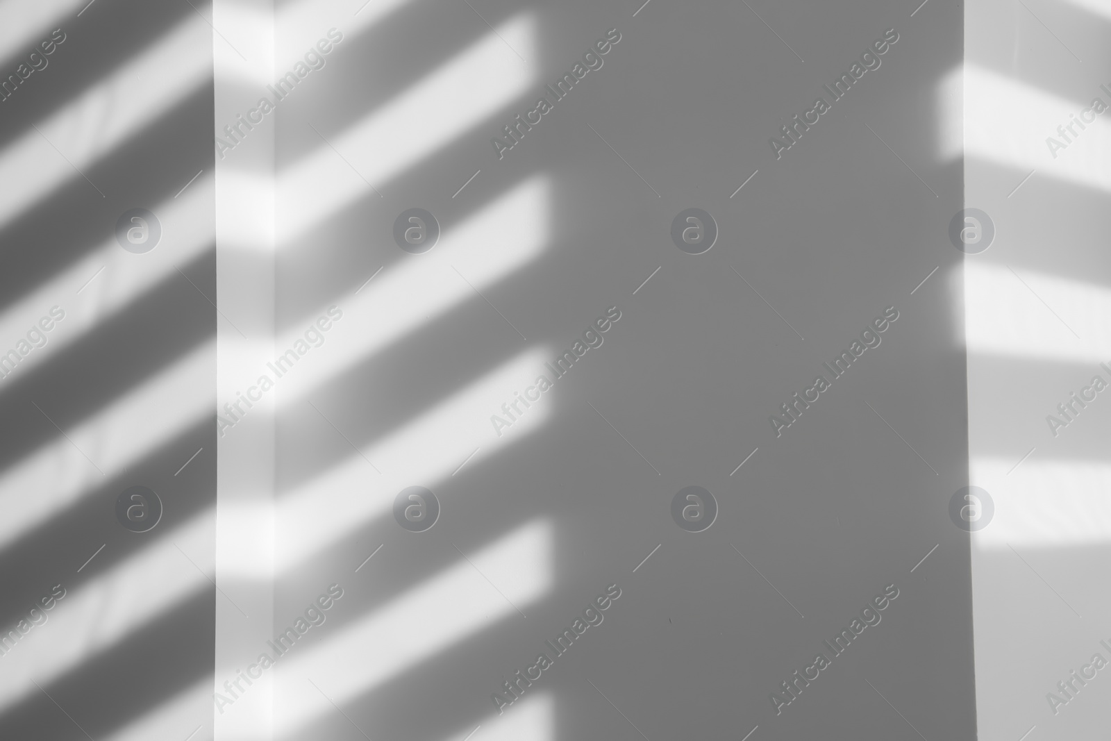 Photo of Lines made of light and shadows on white wall